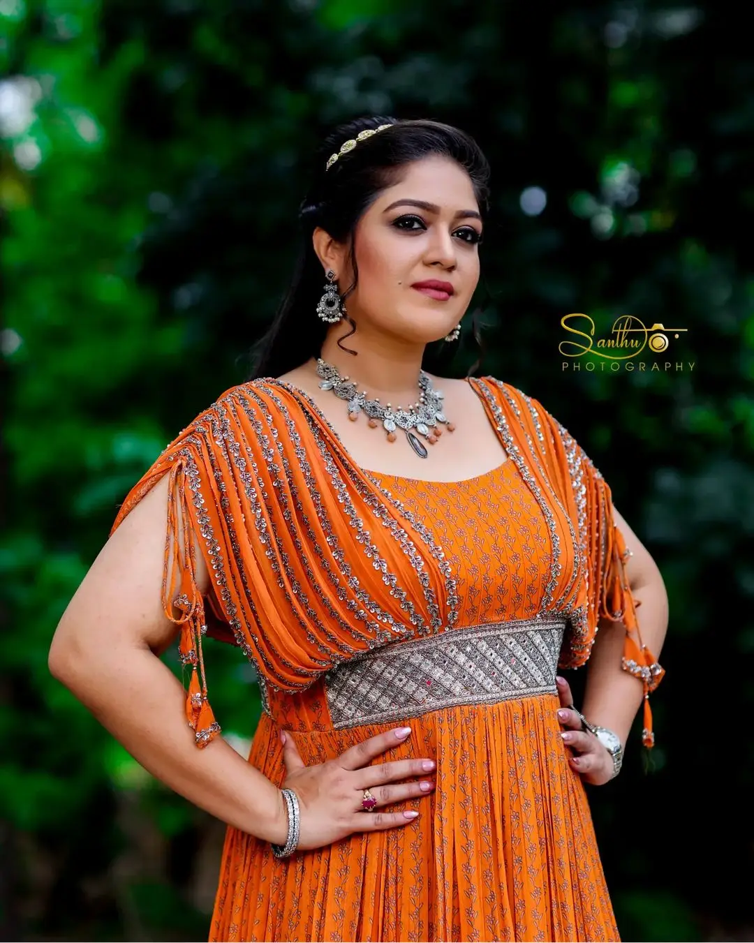 Meghana Raj Wearing Beautiful Earring Jewellery Orange Gown